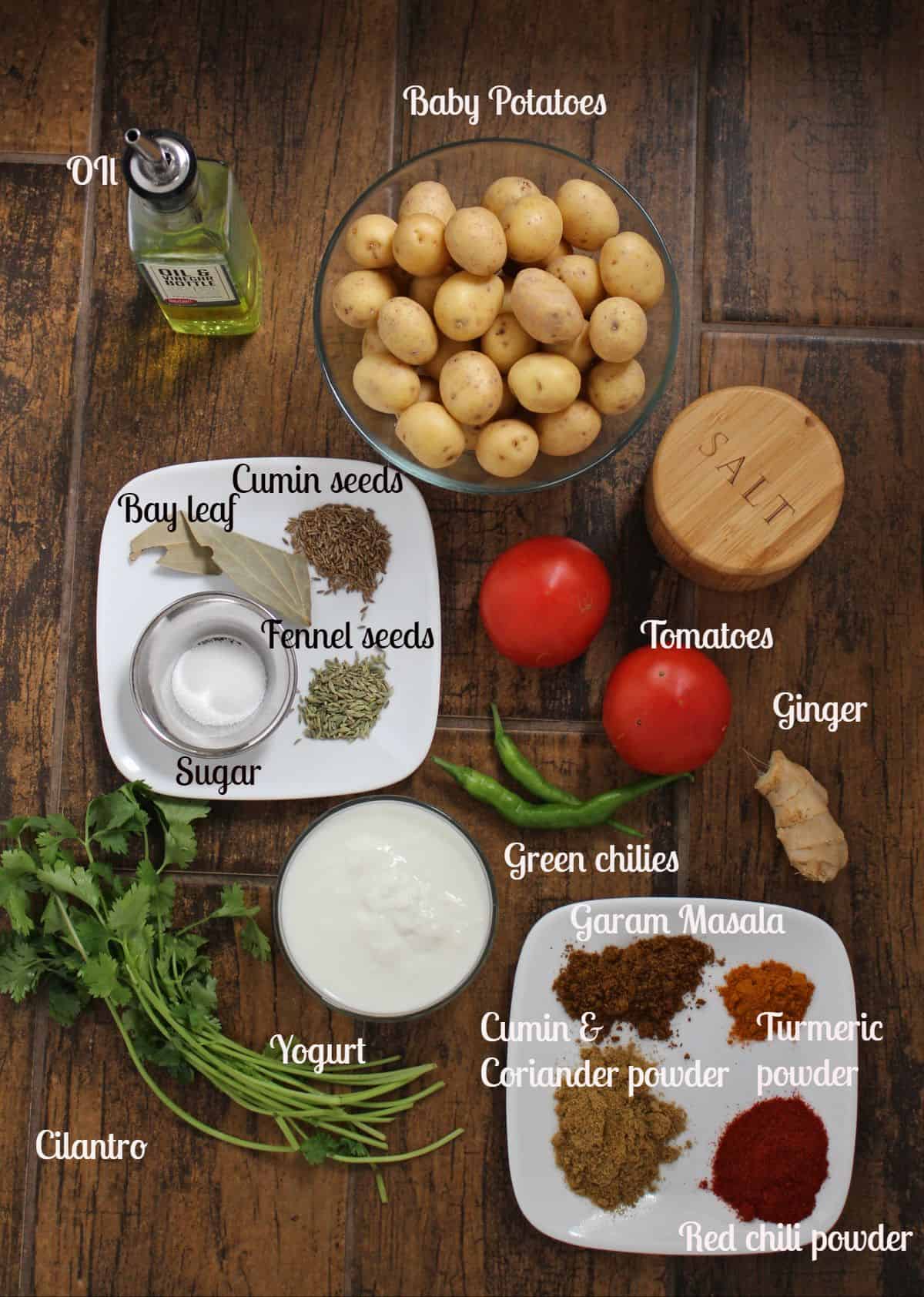 Ingredients laid out and labeled to make Dum aloo recipe