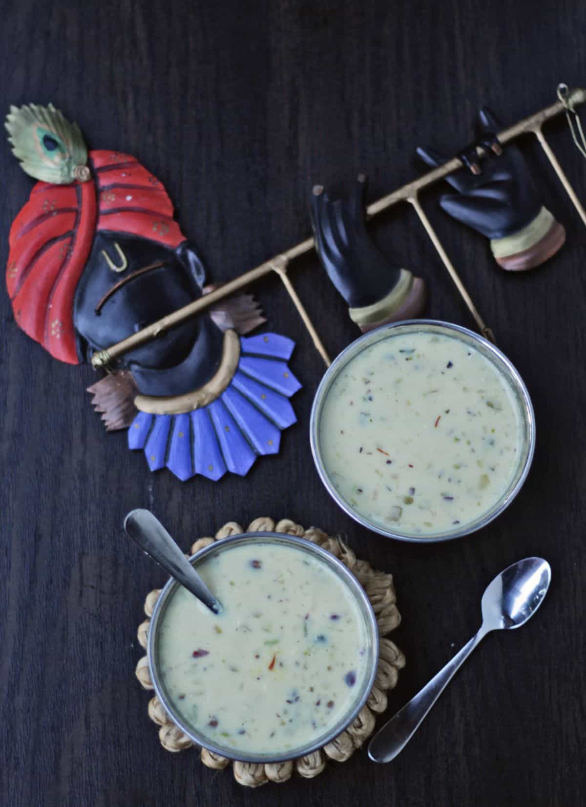 Basundi dessert in 2 cups with a spoon