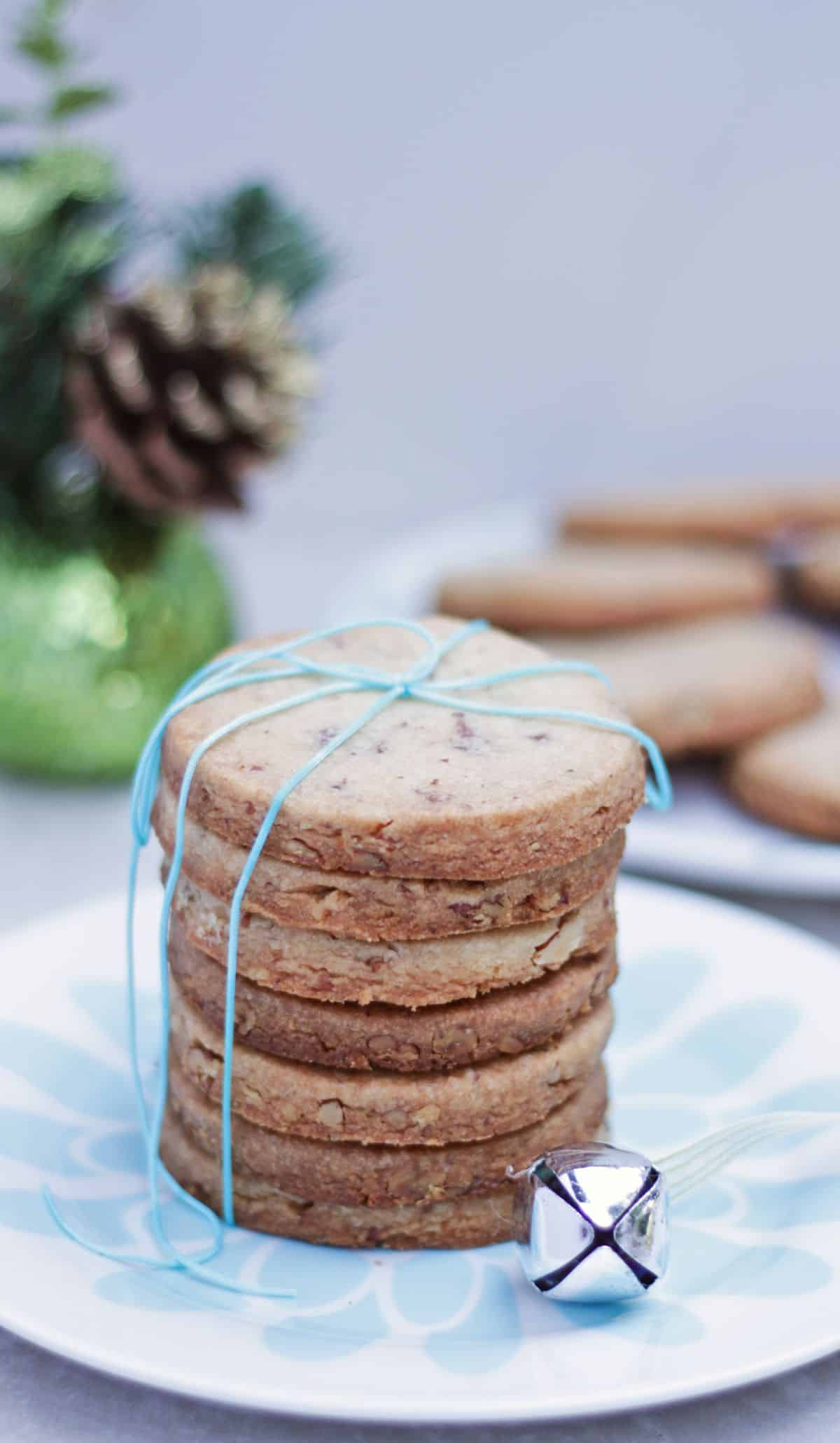 Pecan shortbread sandies cookies stacked and tied in a blue thread