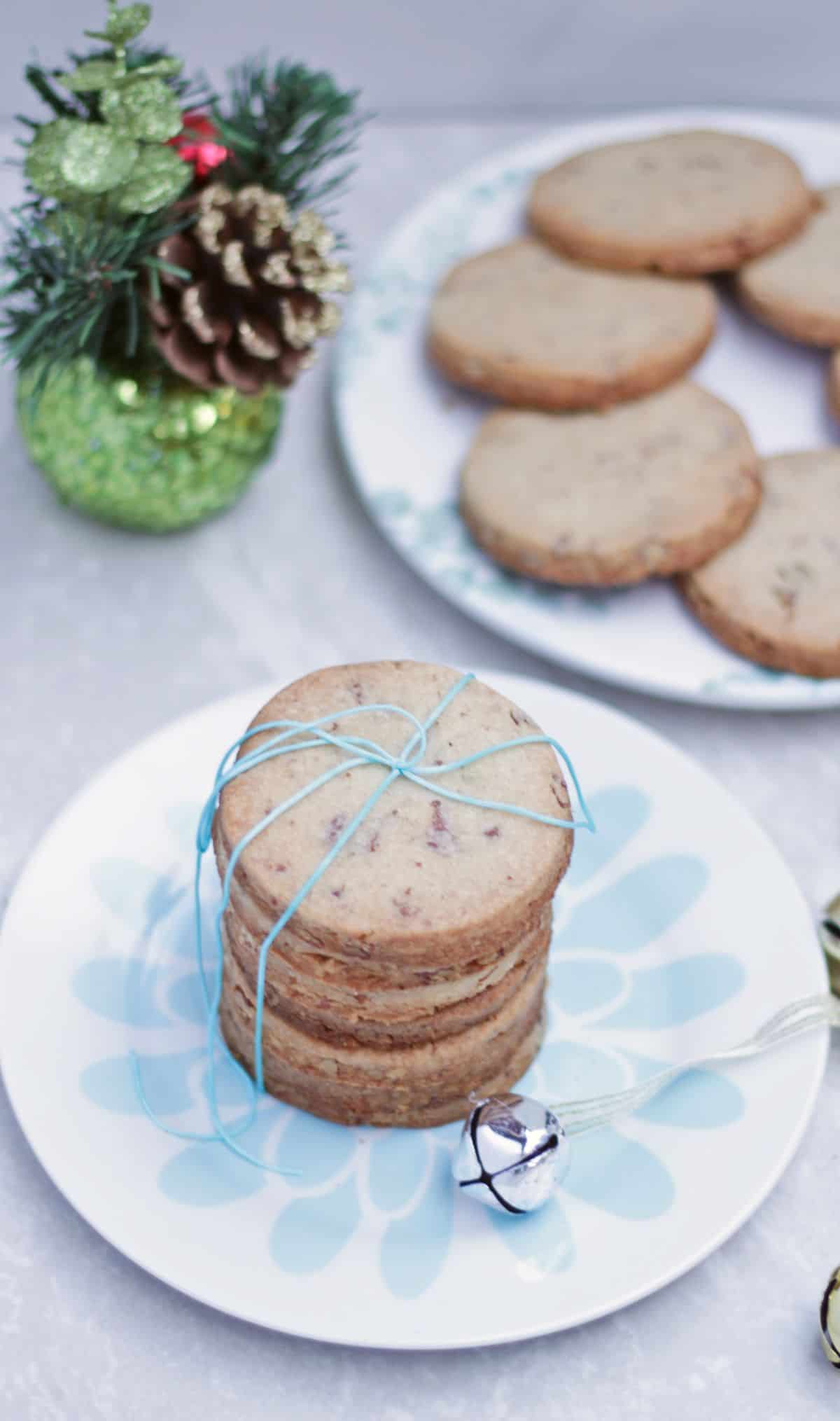 Stacked sandies cookies with Christmas decoration in the background