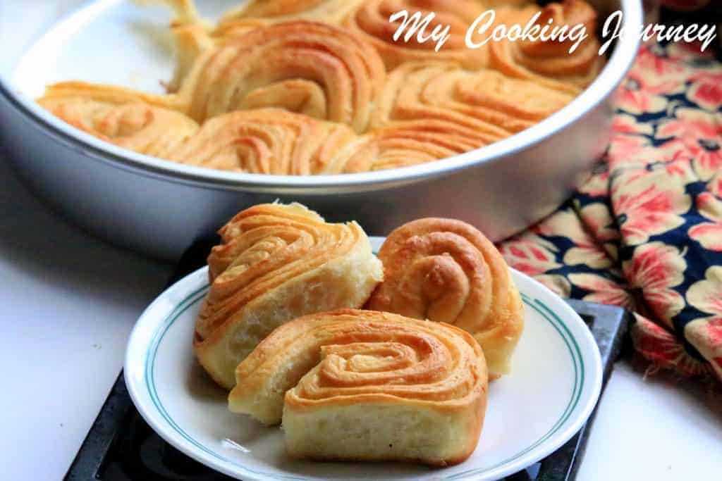 Sweet swirl Buns on a dish and in a tin also