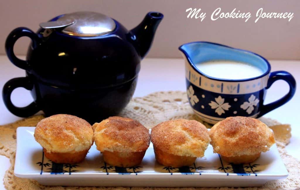 Cinnamon Sugar Muffins in a blue white dish with milk and cup