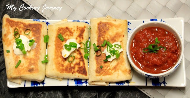 Vegetarian Chimichangas serving with red sauce