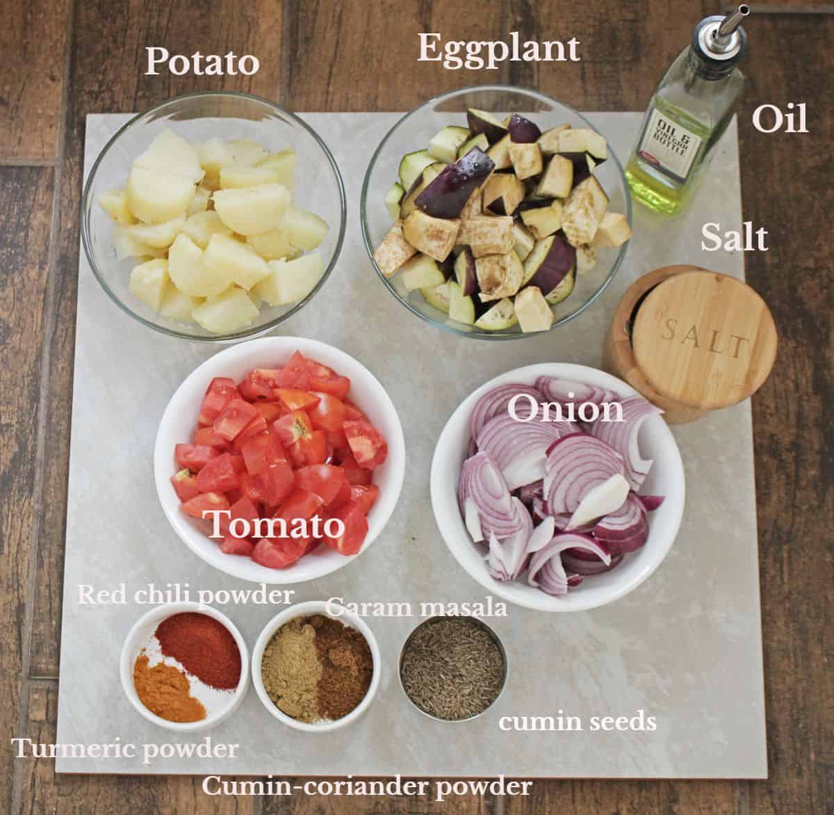 Ingredients measured and laid out for Aloo Baingan recipe