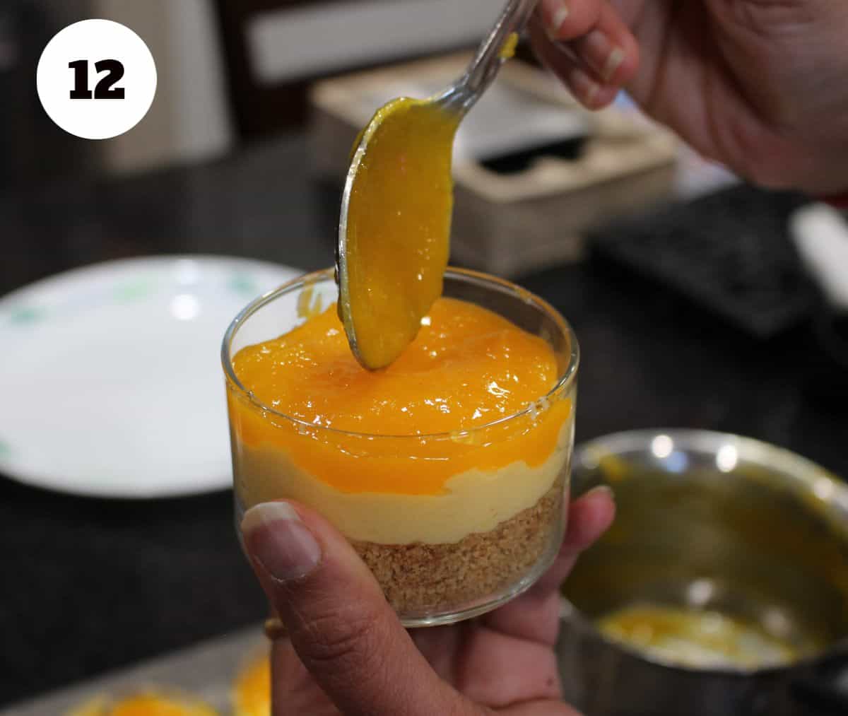 Layering the mango layer on the cheesecake