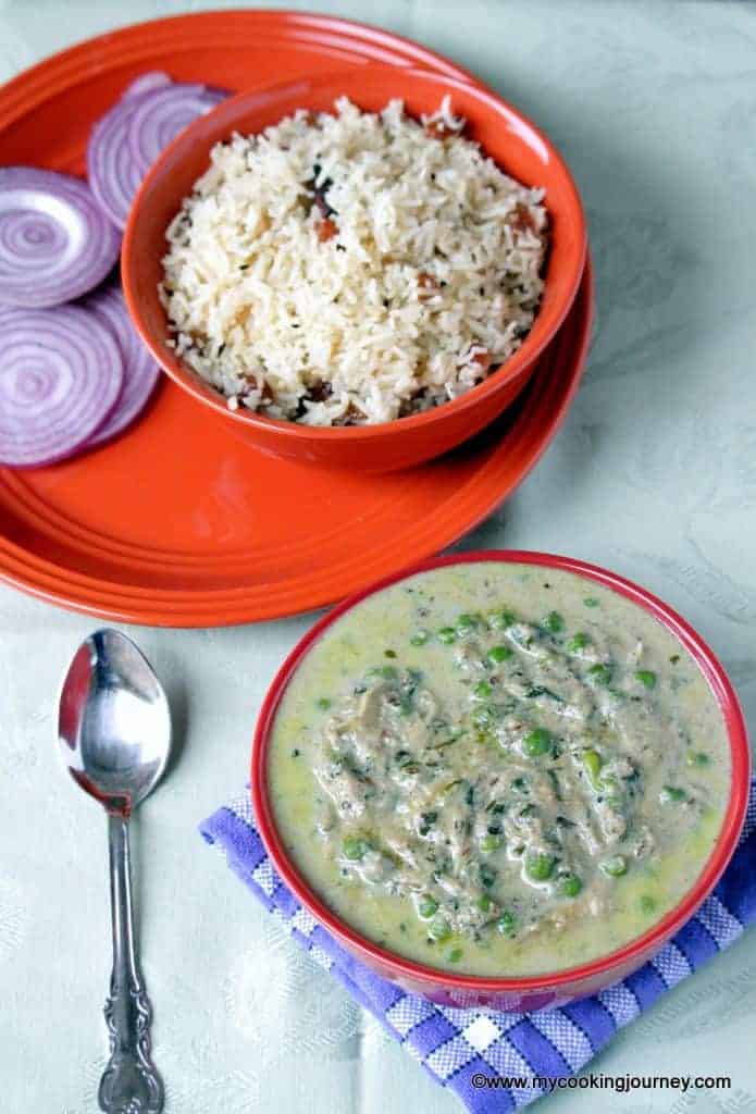 Methi Malai Mutter served in a dish with some onion
