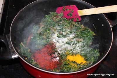 Add spinach and dry spice powder and cook it