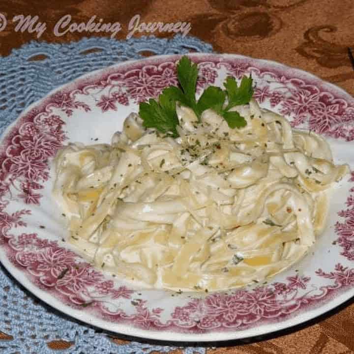 Fettuccine Alfredo in a decorated plate - feature image