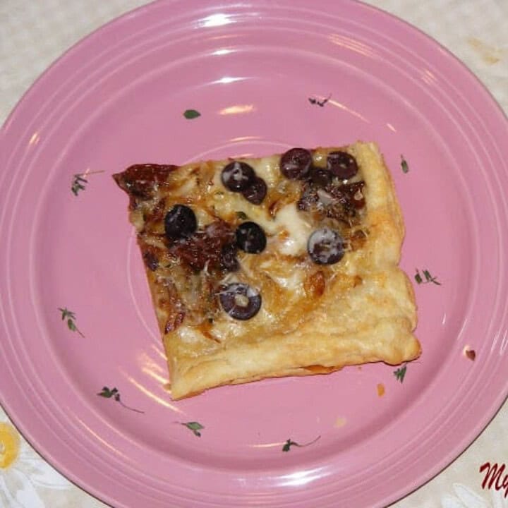 Sun Dried Tomato And Onion Tart in a pink plate - Feature Image